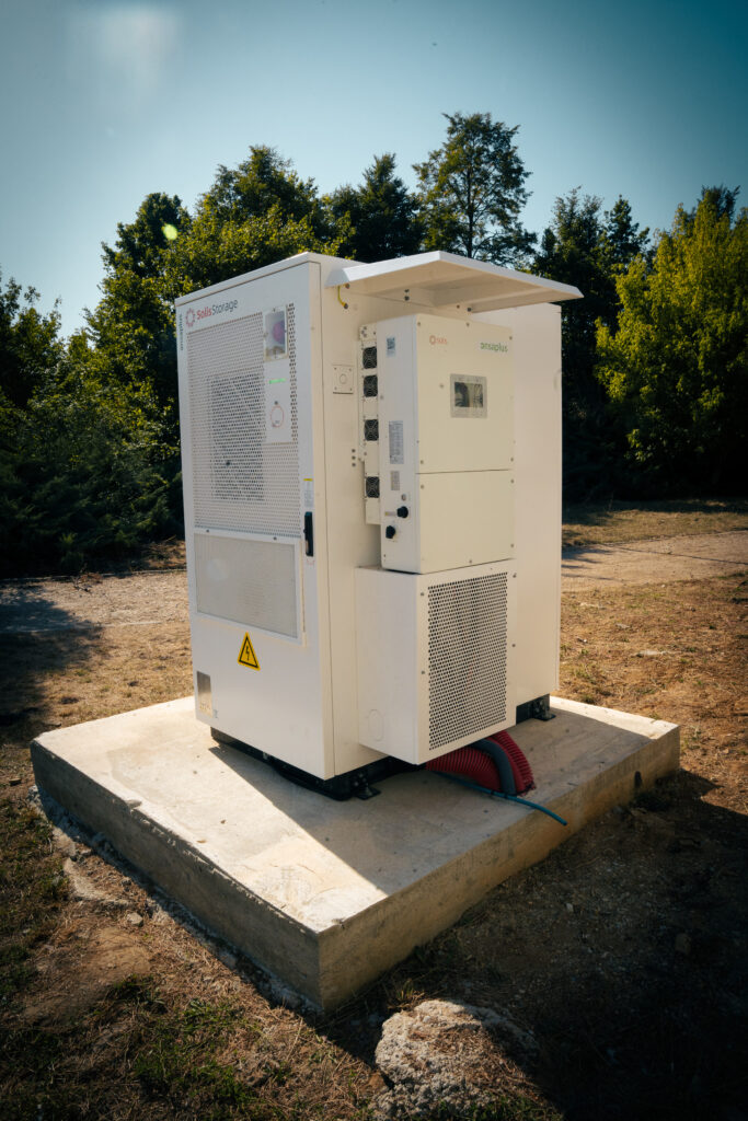 Battery storage cabinet on its concrete base at the farm in Žarnov