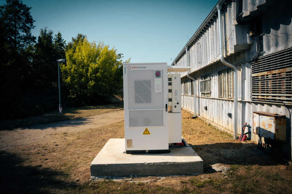 Battery storage cabinet on a concrete base beside the farm building in Žarnov